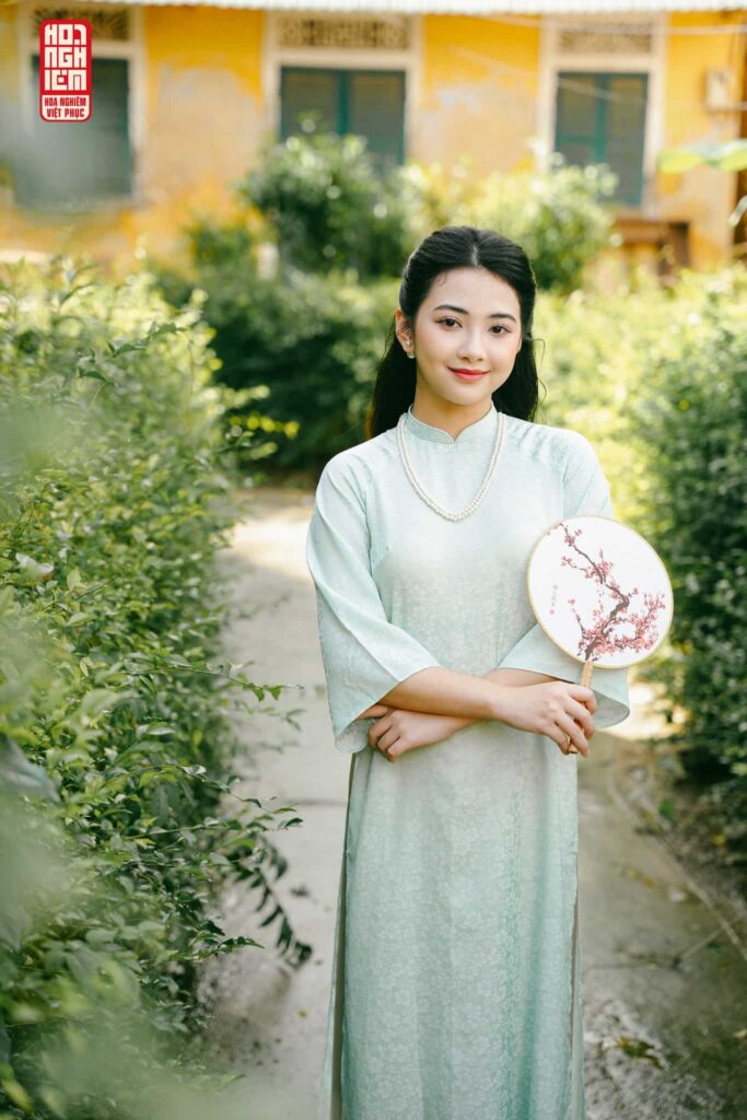 Thiếu nữ trong trang phục áo dài màu xanh chụp hình concept tết
