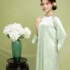 Áo dài suông cổ tròn đính đá với thiết kế tay loe cách tân màu xanh pastel nhẹ nhàng, chuẩn phong cách Áo dài suông ở Huế sang trọng và tinh tế.