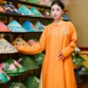 Khánh Mộc - Ngũ Thân nữ màu cam nghệ họa tiết hoa đính kết ngọc ở ngực trái